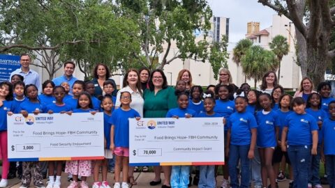 Food Brings Hope FBH Community Check - Grooup of people standing with check